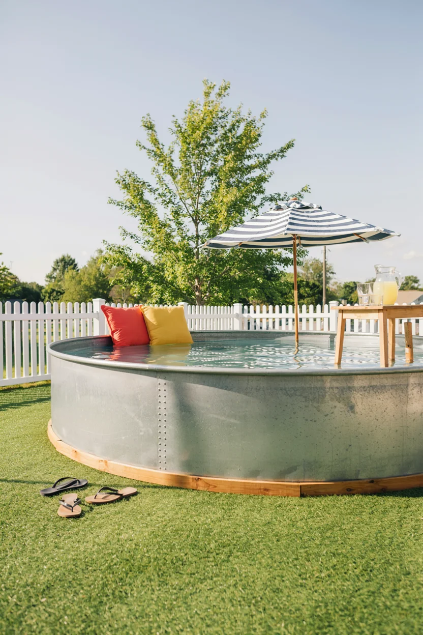 Stock Tank Pool Surrounded by a Turf Lawn