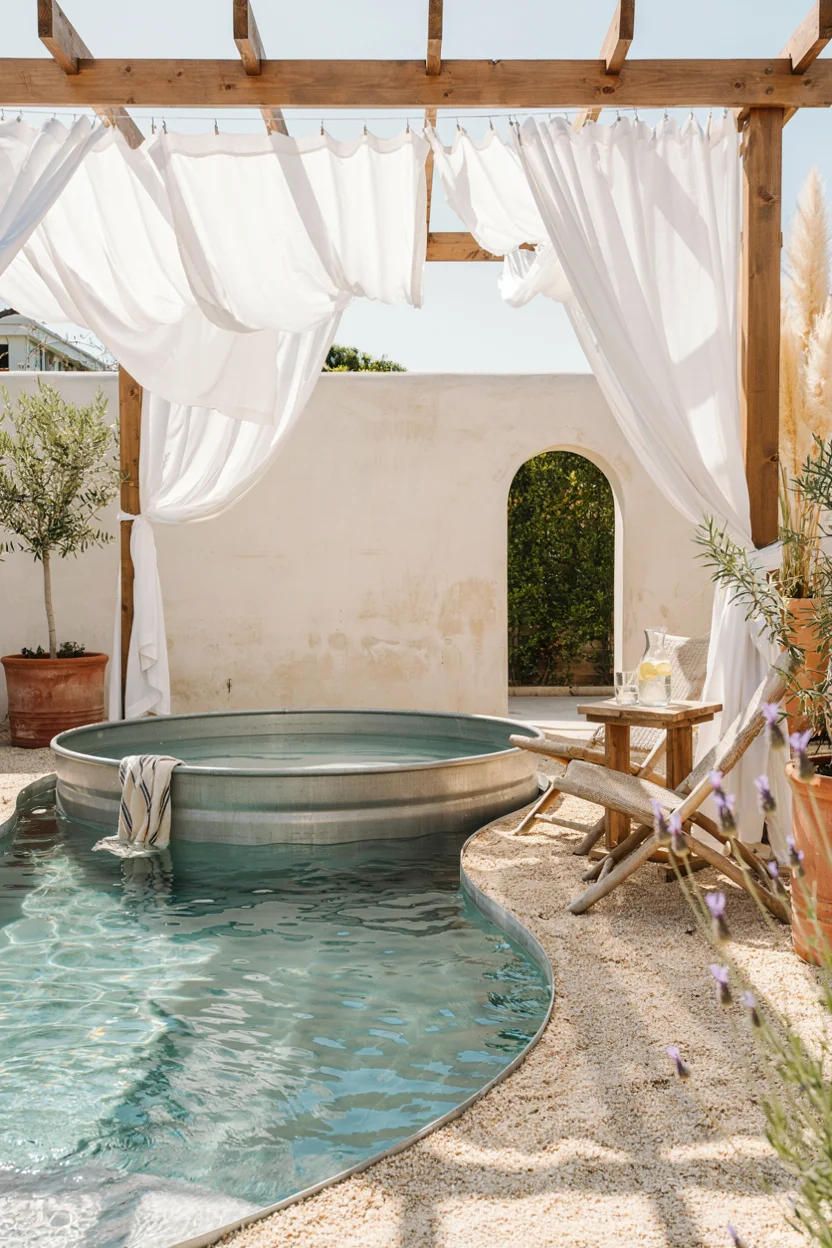 Stock Tank Pool With a Poolside Pergola and Curtains